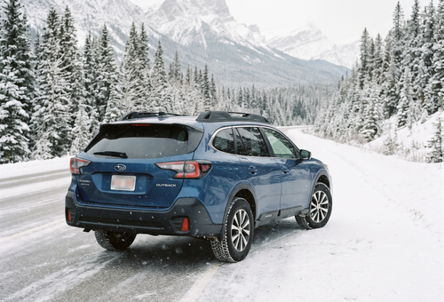 AWD vehicle on a snowy Calgary road with winter tires